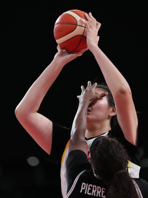 (260921) -- NAGOYA, Sept. 21, 2026 (Xinhua) -- Zhang Ziyu (top) of China is blocked during the women's group A basketball match between China and Indonesia at the 20th Asian Games Aichi-Nagoya 2026 in Nagoya, Japan, Sept. 21, 2026. (Xinhua/Luo Yuan)