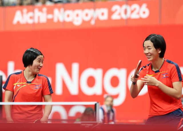 (260921) -- TOYOTA, Sept. 21, 2026 (Xinhua) -- Kim Kum Yong (L)/Cha Su Yong of the Democratic People's Republic of Korea (DPRK) communicate during the women's doubles group stage first-round match against Tushi Samanta/Mahi Nowrin of Bangladesh at the 20th Asian Games Aichi-Nagoya 2026 in Toyota, Japan, Sept. 21, 2026. (Xinhua/Yao Qilin)