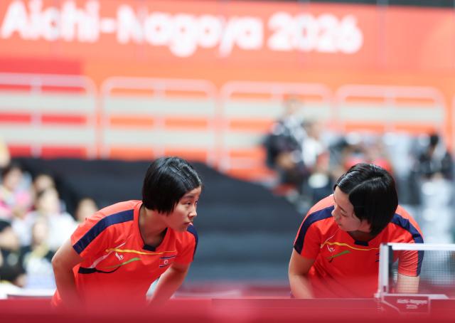 (260921) -- TOYOTA, Sept. 21, 2026 (Xinhua) -- Kim Kum Yong (L)/Cha Su Yong of the Democratic People's Republic of Korea (DPRK) communicate during the women's doubles group stage first-round match against Tushi Samanta/Mahi Nowrin of Bangladesh at the 20th Asian Games Aichi-Nagoya 2026 in Toyota, Japan, Sept. 21, 2026. (Xinhua/Yao Qilin)