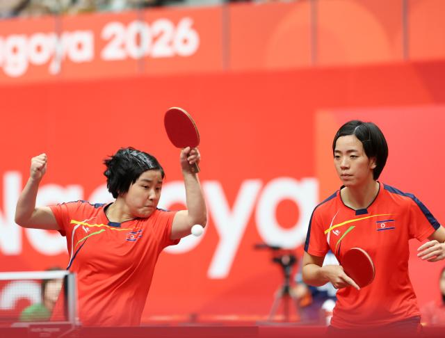 (260921) -- TOYOTA, Sept. 21, 2026 (Xinhua) -- Kim Kum Yong (L)/Cha Su Yong of the Democratic People's Republic of Korea (DPRK) compete during the women's doubles group stage first-round match against Tushi Samanta/Mahi Nowrin of Bangladesh at the 20th Asian Games Aichi-Nagoya 2026 in Toyota, Japan, Sept. 21, 2026. (Xinhua/Yao Qilin)
