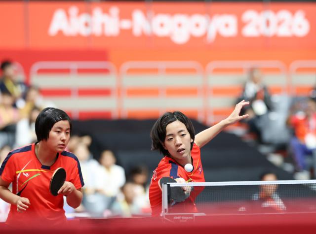 (260921) -- TOYOTA, Sept. 21, 2026 (Xinhua) -- Kim Kum Yong/Cha Su Yong (R) of the Democratic People's Republic of Korea (DPRK) compete during the women's doubles group stage first-round match against Tushi Samanta/Mahi Nowrin of Bangladesh at the 20th Asian Games Aichi-Nagoya 2026 in Toyota, Japan, Sept. 21, 2026. (Xinhua/Yao Qilin)