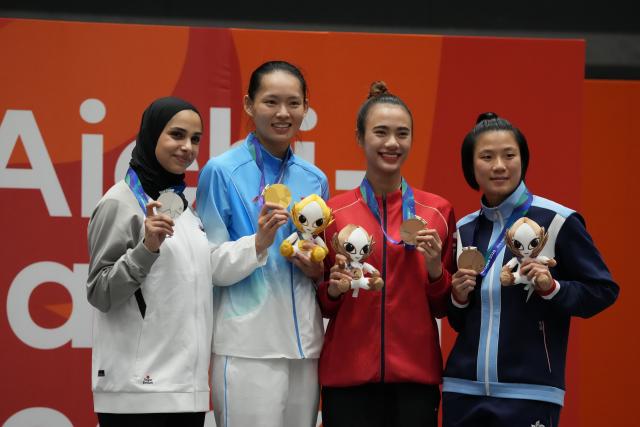 (260921) -- TOYOHASHI, Sept. 21, 2026 (Xinhua) -- Gold Medalist Li Qiaoqiao (2nd L) of China, silver medalist Joud Aldrous (1st L) of Jordan, bronze medalists Nguyen Thi Dieu Ly (2nd R) of Vietnam and Wong Cheuk Lee of China's Hong Kong pose for photos during the awarding ceremony after the women's kumite 68kg final of Karate at the 20th Asian Games Aichi-Nagoya 2026 in Toyohashi of Aichi Prefecture, Japan, Sept. 21, 2026. (Xinhua/Zhou Mi)
