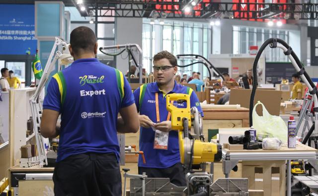 (260921) -- SHANGHAI, Sept. 21, 2026 (Xinhua) -- Competitors from Brazil prepare for the 48th WorldSkills Competition at the National Exhibition and Convention Center (Shanghai) in east China's Shanghai, Sept. 21, 2026. The 48th WorldSkills Competition is scheduled to take place from September 22 to 27 in Shanghai. (Xinhua/Fang Zhe)