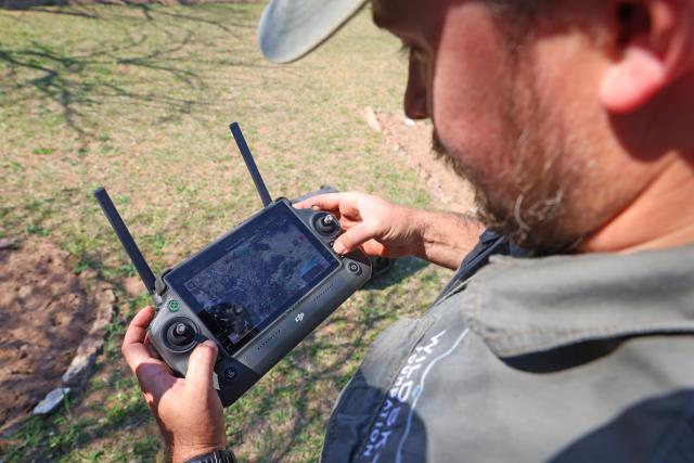 (260921) -- KWAZULU-NATAL, Sept. 21, 2026 (Xinhua) -- A park officer conducts patrol using a drone at Hluhluwe-iMfolozi Park in KwaZulu-Natal Province, South Africa, Aug. 19, 2026. TO GO WITH "Feature: Smart technology strengthens rhino protection at South Africa's historic reserve" (Xinhua/Chen Wei)