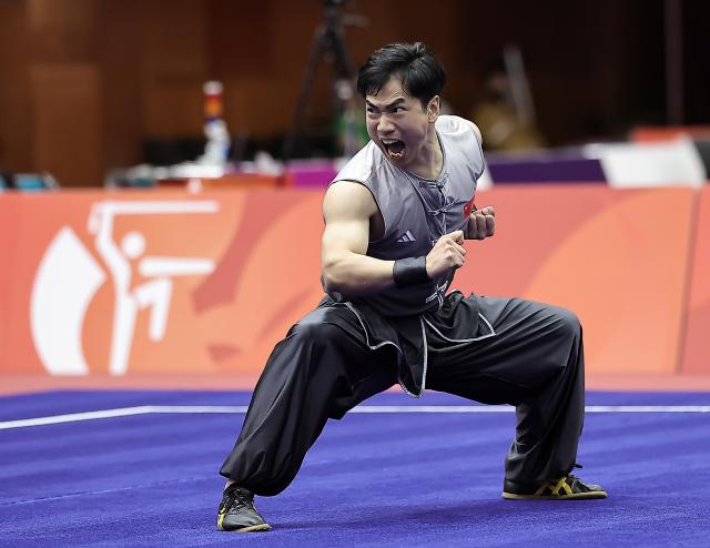 (260922) -- NAGOYA, Sept. 22, 2026 (Xinhua) -- Li Jianming of China competes during the Nanquan round of the men's Nanquan and Nangun final of Wushu at the 20th Asian Games Aichi-Nagoya 2026 in Nagoya of Aichi Prefecture, Japan, Sept. 22, 2026. (Xinhua/Long Lei)