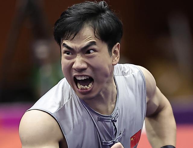 (260922) -- NAGOYA, Sept. 22, 2026 (Xinhua) -- Li Jianming of China competes during the Nanquan round of the men's Nanquan and Nangun final of Wushu at the 20th Asian Games Aichi-Nagoya 2026 in Nagoya of Aichi Prefecture, Japan, Sept. 22, 2026. (Xinhua/Long Lei)