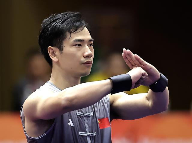 (260922) -- NAGOYA, Sept. 22, 2026 (Xinhua) -- Li Jianming of China competes during the Nanquan round of the men's Nanquan and Nangun final of Wushu at the 20th Asian Games Aichi-Nagoya 2026 in Nagoya of Aichi Prefecture, Japan, Sept. 22, 2026. (Xinhua/Long Lei)