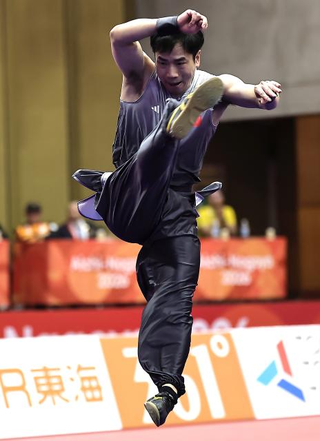 (260922) -- NAGOYA, Sept. 22, 2026 (Xinhua) -- Li Jianming of China competes during the Nanquan round of the men's Nanquan and Nangun final of Wushu at the 20th Asian Games Aichi-Nagoya 2026 in Nagoya of Aichi Prefecture, Japan, Sept. 22, 2026. (Xinhua/Long Lei)