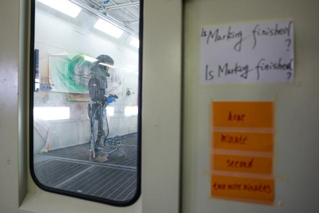 (260922) -- BEIJING, Sept. 22, 2026 (Xinhua) -- English words and phrases posted outside the spray-painting booth by Duan Libo are pictured at a training facility of Hangzhou Technician Institute in Hangzhou, east China's Zhejiang Province, Sept. 7, 2026. Duan Libo, born in southwest China's Yunnan Province in 2004, is a student majoring in automotive sheet metal and painting at Hangzhou Technician Institute. He has been preparing for the car painting skill competition at the 48th WorldSkills Competition in Shanghai.
   At the training facility, Duan, dressed in full protective gear, conducted practical training under the guidance of coaches, translators, and assistants. Coach Jiang Yingcheng, who won the championship in car painting at the 44th WorldSkills Competition, said this year's competition places higher demands on participants' skills, physical fitness, and mental resilience. (Xinhua/Jiang Han)