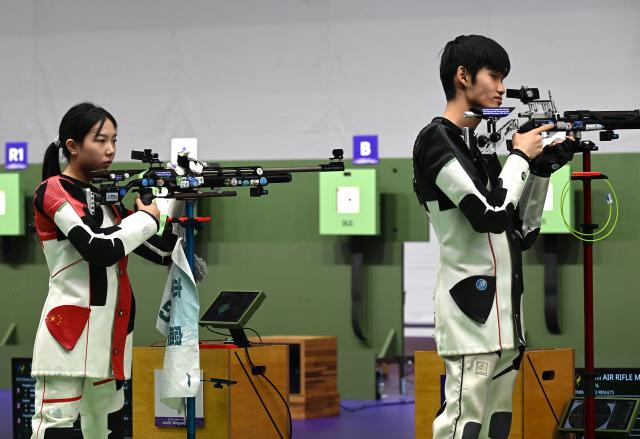 (260922) -- NAGOYA, Sept. 22, 2026 (Xinhua) -- Wang Zifei (L) and Sheng Lihao of team China compete during the 10m air rifle mixed team final of shooting at the 20th Asian Games Aichi-Nagoya 2026 in Toyota of Aichi Prefecture, Japan, Sept. 22, 2026. (Xinhua/Liu Lei)