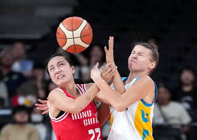 (260922) -- NAGOYA, Sept. 22, 2026 (Xinhua) -- Tsui Wing Yu (L) of Hong Kong, China and Valeriya Kapitonova of Kazakhstan fight for the ball during the women's group B match between Hong Kong, China and Kazakhstan at 20th Asian Games Aichi-Nagoya 2026 in Nagoya, Japan, Sept. 22, 2026. (Xinhua/Luo Yuan)