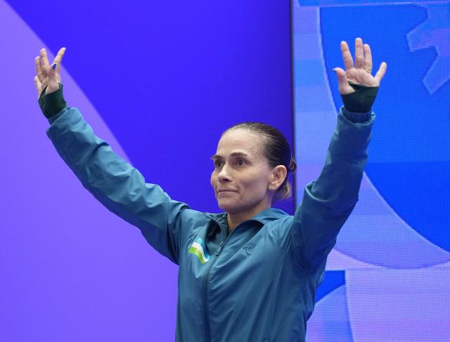 (260922) -- NAGOYA, Sept. 22, 2026 (Xinhua) -- Oksana Chusovitina of Uzbekistan greets spectators before the women's vault qualification of Artistic Gymnastics at the 20th Asian Games Aichi-Nagoya 2026 in Nagoya, Japan, Sept. 22, 2026. (Xinhua/Lui Siu Wai)
