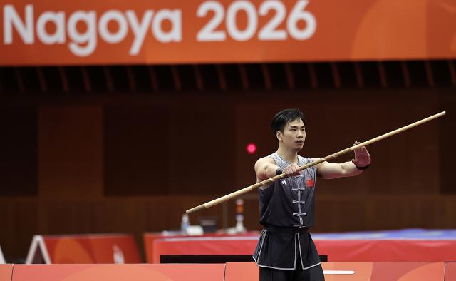 (260922) -- NAGOYA, Sept. 22, 2026 (Xinhua) -- Li Jianming of China competes during the Nangun round of the men's Nanquan and Nangun final of Wushu at the 20th Asian Games Aichi-Nagoya 2026 in Nagoya of Aichi Prefecture, Japan, Sept. 22, 2026. (Xinhua/Long Lei)