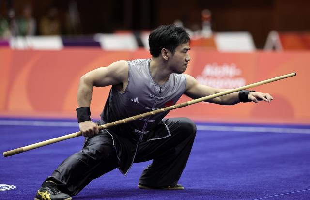 (260922) -- NAGOYA, Sept. 22, 2026 (Xinhua) -- Li Jianming of China competes during the Nangun round of the men's Nanquan and Nangun final of Wushu at the 20th Asian Games Aichi-Nagoya 2026 in Nagoya of Aichi Prefecture, Japan, Sept. 22, 2026. (Xinhua/Long Lei)