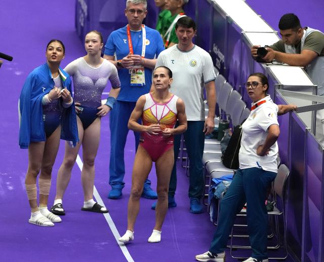 (260922) -- NAGOYA, Sept. 22, 2026 (Xinhua) -- Oksana Chusovitina (C) of Uzbekistan waits for her score during the women's vault qualification of Artistic Gymnastics at the 20th Asian Games Aichi-Nagoya 2026 in Nagoya, Japan, Sept. 22, 2026. (Xinhua/Jia Yuchen)