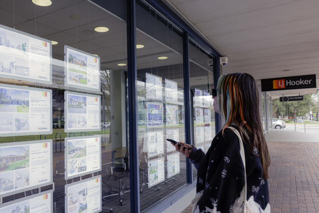 (260922) -- CANBERRA, Sept. 22, 2026 (Xinhua) -- A young woman views property advertisements in Canberra, Australia, on Sept. 22, 2026. TO GO WITH "Younger Australians locked out of housing market: gov't report" (Photo by Chu Chen/Xinhua)