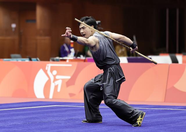 (260922) -- NAGOYA, Sept. 22, 2026 (Xinhua) -- Li Jianming of China competes during the Nangun round of the men's Nanquan and Nangun final of Wushu at the 20th Asian Games Aichi-Nagoya 2026 in Nagoya, Japan, Sept. 22, 2026. (Xinhua/Long Lei)