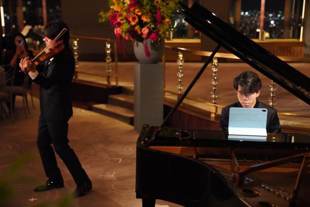 (260922) -- NEW YORK, Sept. 22, 2026 (Xinhua) -- Violinist Huang Mengla and pianist Aristo Sham perform during a concert named Moonlit Melodies to celebrate the upcoming Mid-Autumn Festival at the Rainbow Room of Rockefeller Center in New York, the United States, on Sept. 21, 2026. The Mid-Autumn Festival in China, which is celebrated annually on the 15th day of the eighth month in the Chinese lunar calendar, falls on Sept. 25 this year. (Xinhua/Zhang Fengguo)
