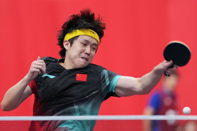 (260922) -- TOYOTA, Sept. 22, 2026 (Xinhua) -- Wang Chuqin of China hits a return to Phakpoom Sanguansin of Thailand during the men's team quarterfinal match between China and Thailand at the 20th Asian Games Aichi-Nagoya 2026 in Toyota, Japan, Sept. 22, 2026. (Xinhua/Cheong Kam Ka)