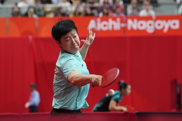 (260922) -- TOYOTA, Sept. 22, 2026 (Xinhua) -- Sun Yingsha of China hits a return to Asel Erkebaeva of Uzbekistan during the women's team quarterfinal match between China and Uzbekistan at the 20th Asian Games Aichi-Nagoya 2026 in Toyota, Japan, Sept. 22, 2026. (Xinhua/Cheong Kam Ka)