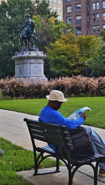 (260922) -- WASHINGTON, Sept. 22, 2026 (Xinhua) -- This photo taken with a mobile phone shows a man reading a newspaper at a garden in Washington, D.C., the United States, Sept. 19, 2026. (Xinhua/Wang Ye)