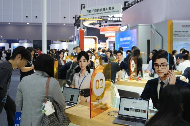 (260922) -- HANGZHOU, Sept. 22, 2026 (Xinhua) -- People learn about AI products and applications during the 2026 Apsara Conference in Hangzhou, east China's Zhejiang Province, Sept. 22, 2026. The 2026 Apsara Conference opened here on Tuesday, and will last for three days. The conference has three main forums and more than 120 sub-forums. (Xinhua/Huang Zongzhi)