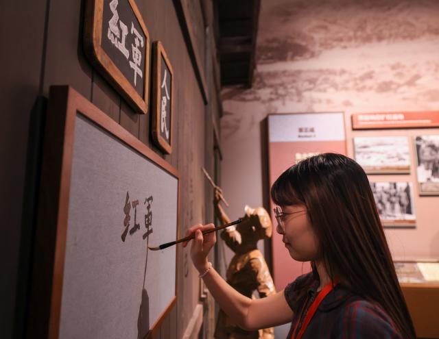 (260922) -- BEIJING, Sept. 22, 2026 (Xinhua) -- A woman visits a themed exhibition commemorating the 90th anniversary of the victory of the Long March at the Military Museum of the Chinese People's Revolution during a media preview in Beijing, capital of China, Sept. 21, 2026. The exhibition opened here on Tuesday, taking up approximately 3,300 square meters on the western side of the museum's third floor, with a display route stretching more than 760 meters. (Xinhua/Yin Gang)