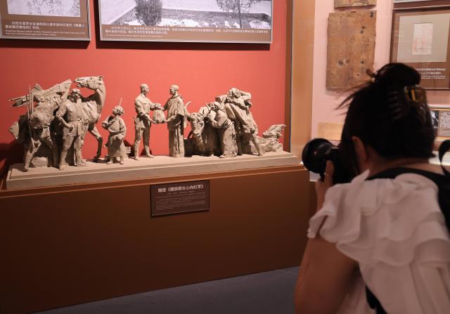 (260922) -- BEIJING, Sept. 22, 2026 (Xinhua) -- A woman visits a themed exhibition commemorating the 90th anniversary of the victory of the Long March at the Military Museum of the Chinese People's Revolution during a media preview in Beijing, capital of China, Sept. 21, 2026. The exhibition opened here on Tuesday, taking up approximately 3,300 square meters on the western side of the museum's third floor, with a display route stretching more than 760 meters. (Xinhua/Yin Gang)