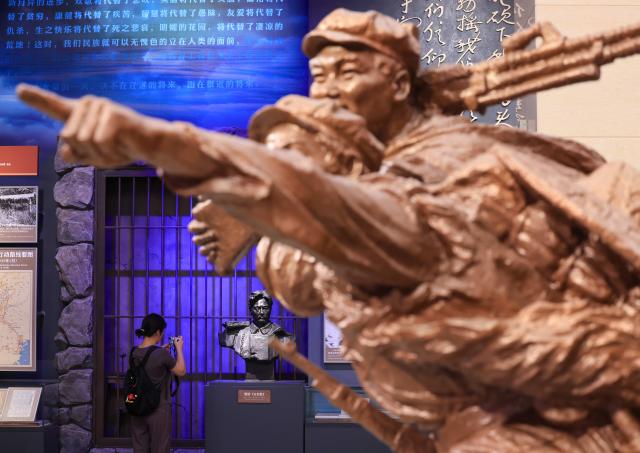(260922) -- BEIJING, Sept. 22, 2026 (Xinhua) -- A woman visits a themed exhibition commemorating the 90th anniversary of the victory of the Long March at the Military Museum of the Chinese People's Revolution during a media preview in Beijing, capital of China, Sept. 21, 2026. The exhibition opened here on Tuesday, taking up approximately 3,300 square meters on the western side of the museum's third floor, with a display route stretching more than 760 meters. (Xinhua/Yin Gang)