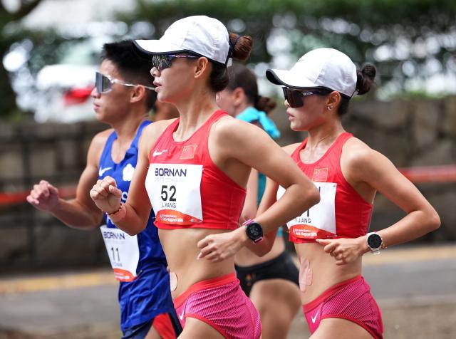 (260923) -- NAGOYA, Sept. 23, 2026 (Xinhua) -- Yang Liujing (2nd L) and Jiang Yunyan (1st R) of China compete during the Women's Half Marathon Race Walk Final of Athletics at the 20th Asian Games Aichi-Nagoya 2026 in Nagoya, Japan, Sept. 23, 2026. (Xinhua/Luo Yuan)