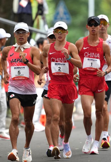 (260923) -- NAGOYA, Sept. 23, 2026 (Xinhua) -- Shi Shengji (C) and Li Chenjie (R) of China, Yamanishi Toshikazu of Japan compete during the Men's Half Marathon Race Walk Final of Athletics at the 20th Asian Games Aichi-Nagoya 2026 in Nagoya, Japan, Sept. 23, 2026. (Xinhua/Jia Yuchen)