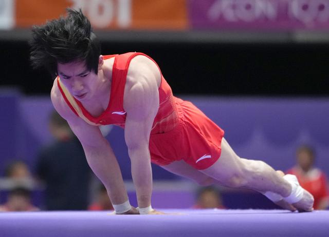(260923) -- NAGOYA, Sept. 23, 2026 (Xinhua) -- Zhang Boheng of team China competes during the floor exercise competition of men's team final of Artistic Gymnastics at the 20th Asian Games Aichi-Nagoya 2026 in Nagoya, Japan, Sept. 23, 2026. (Xinhua/Lui Siu Wai)