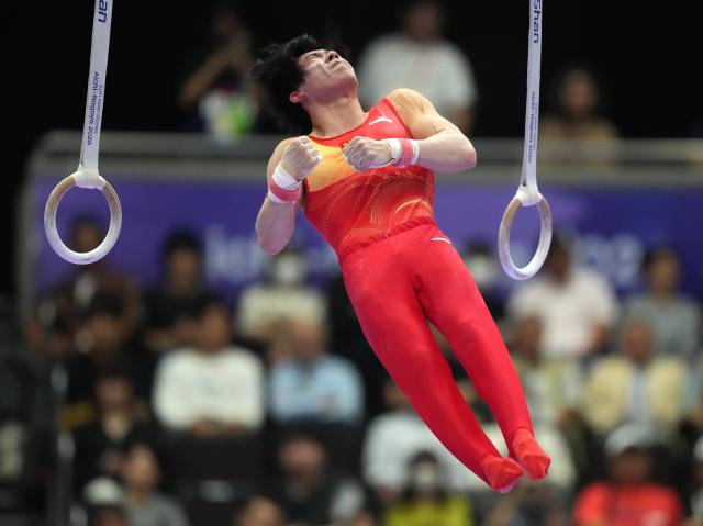(260923) -- NAGOYA, Sept. 23, 2026 (Xinhua) -- Zhang Boheng of team China competes during the rings competition of men's team final of Artistic Gymnastics at the 20th Asian Games Aichi-Nagoya 2026 in Nagoya, Japan, Sept. 23, 2026. (Xinhua/Lui Siu Wai)