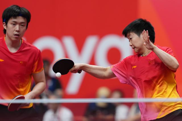(260923) -- TOYOTA, Sept. 23, 2026 (Xinhua) -- Wang Chuqin/Sun Yingsha (R) compete during the mixed doubles round 3 match between Wang Chuqin/Sun Yingsha (China) and Feng Yi-hsin/Yeh Yi-tian (Chinese Taipei) at the 20th Asian Games Aichi-Nagoya 2026 in Toyota, Japan, Sept. 23, 2026. (Xinhua/Cheong Kam Ka)