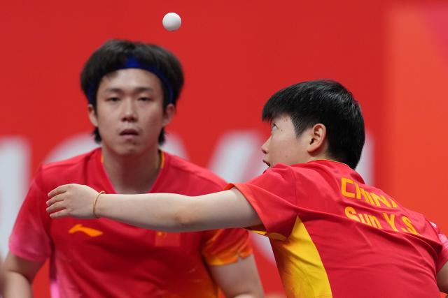 (260923) -- TOYOTA, Sept. 23, 2026 (Xinhua) -- Wang Chuqin/Sun Yingsha (R) compete during the mixed doubles round 3 match between Wang Chuqin/Sun Yingsha (China) and Feng Yi-hsin/Yeh Yi-tian (Chinese Taipei) at the 20th Asian Games Aichi-Nagoya 2026 in Toyota, Japan, Sept. 23, 2026. (Xinhua/Cheong Kam Ka)