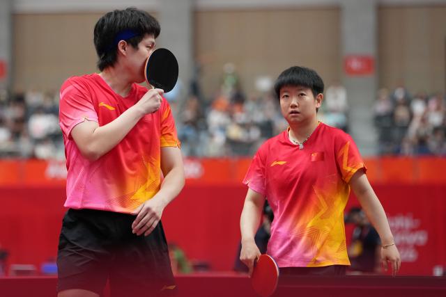 (260923) -- TOYOTA, Sept. 23, 2026 (Xinhua) -- Wang Chuqin/Sun Yingsha (R) react during the mixed doubles round 3 match between Wang Chuqin/Sun Yingsha (China) and Feng Yi-hsin/Yeh Yi-tian (Chinese Taipei) at the 20th Asian Games Aichi-Nagoya 2026 in Toyota, Japan, Sept. 23, 2026. (Xinhua/Cheong Kam Ka)
