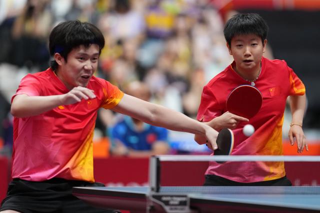 (260923) -- TOYOTA, Sept. 23, 2026 (Xinhua) -- Wang Chuqin/Sun Yingsha (R) compete during the mixed doubles round 3 match between Wang Chuqin/Sun Yingsha (China) and Feng Yi-hsin/Yeh Yi-tian (Chinese Taipei) at the 20th Asian Games Aichi-Nagoya 2026 in Toyota, Japan, Sept. 23, 2026. (Xinhua/Cheong Kam Ka)