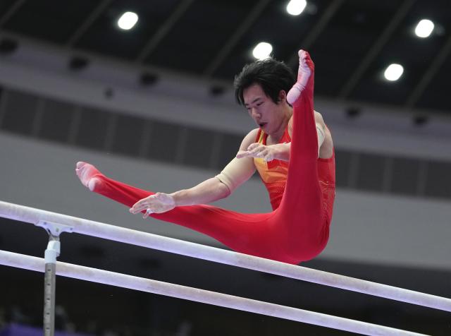 (260923) -- NAGOYA, Sept. 23, 2026 (Xinhua) -- Zhang Boheng of team China competes during the parallel bars competition of men's team final of Artistic Gymnastics at the 20th Asian Games Aichi-Nagoya 2026 in Nagoya, Japan, Sept. 23, 2026. (Xinhua/Lui Siu Wai)