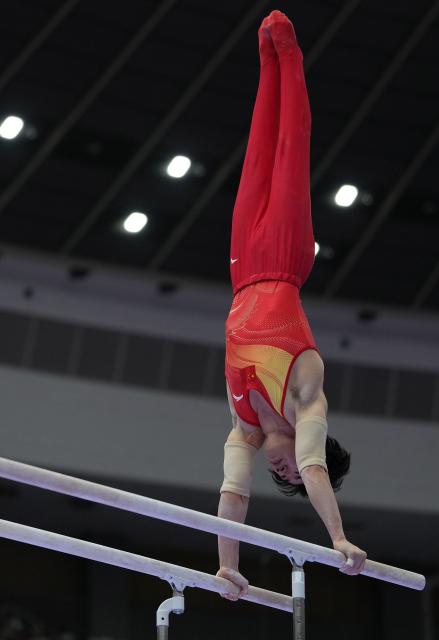 (260923) -- NAGOYA, Sept. 23, 2026 (Xinhua) -- Zhang Boheng of team China competes during the parallel bars competition of men's team final of Artistic Gymnastics at the 20th Asian Games Aichi-Nagoya 2026 in Nagoya, Japan, Sept. 23, 2026. (Xinhua/Lui Siu Wai)