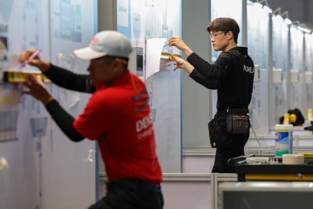 (260923) -- SHANGHAI, Sept. 23, 2026 (Xinhua) -- Contestants participate in the industrial control event during the 48th WorldSkills Competition in east China's Shanghai, Sept. 23, 2026. The competition kicks off at the National Exhibition and Convention Center here on Wednesday. (Xinhua/Wang Jingqiang)