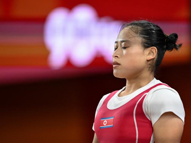 (260923) -- NAGOYA, Sept. 23, 2026 (Xinhua) -- Ri Song Gum of the Democratic People's Republic of Korea reacts during the women's 49kg final of weightlifting at the 20th Asian Games Aichi-Nagoya 2026 in Nagoya, Japan, Sept. 23, 2026. (Xinhua/Yu Yang)