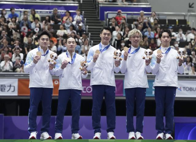 (260923) -- NAGOYA, Sept. 23, 2026 (Xinhua) -- Bronze medalists Chuang Chia-lung, Hung Yuan-hsi, Tang Chia-hung, Lee Chih-kai and Shiao Yu-jan of team Chinese Taipei pose during the awarding ceremony for men's team of Artistic Gymnastics at the 20th Asian Games Aichi-Nagoya 2026 in Nagoya, Japan, Sept. 23, 2026. (Xinhua/Jia Yuchen)