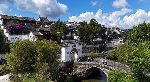 (260923) -- BAOSHAN, Sept. 23, 2026 (Xinhua) -- A drone photo taken on Sept. 22, 2026 shows tourists visiting Heshun ancient town in Baoshan City, southwest China's Yunnan Province. In recent years, Baoshan City has developed distinctive industries such as homestays, camping, dendrobium cultivation and tea. The city is leveraging ecological tourism and cultural resources to advance rural revitalization, injecting new vitality into the high-quality development of its cultural and tourism industries. (Photo by Zhao Hui/Xinhua)