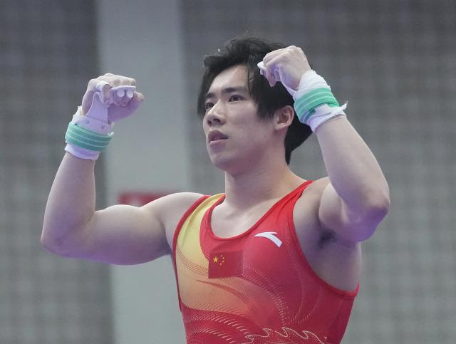 (260923) -- NAGOYA, Sept. 23, 2026 (Xinhua) -- Zhang Boheng of team China reacts after during the horizontal bar competition of men's team final of Artistic Gymnastics at the 20th Asian Games Aichi-Nagoya 2026 in Nagoya, Japan, Sept. 23, 2026. (Xinhua/Jia Yuchen)