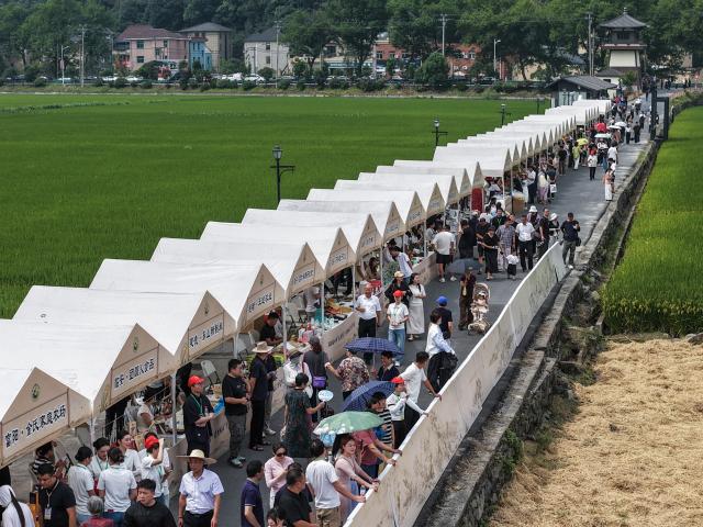 (260923) -- BEIJING, Sept. 23, 2026 (Xinhua) -- A drone photo shows people visiting a market during an event celebrating the ninth Chinese farmers' harvest festival in Yushan Town in Hangzhou, east China's Zhejiang Province, Sept. 23, 2026.
  The Chinese farmers' harvest festival is the first national festival created specifically for the country's farmers. This year's festival falls on Wednesday.
  Launched in 2018, the festival coincides with the Autumnal Equinox each year, which is one of the 24 solar terms of the Chinese lunisolar calendar and usually falls between Sept. 22 and 24 during the country's agricultural harvest season. (Xinhua/Xu Yu)