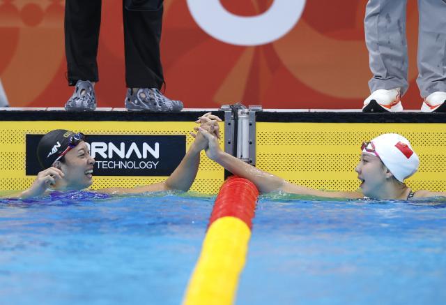(260923) -- TOKYO, Sept. 23, 2026 (Xinhua) -- Tang Qianting (R) of China is congratulated by Suzuki Satomi of Japan after the women's 100m breaststroke final at the 20th Asian Games Aichi-Nagoya 2026 in Tokyo, Japan, Sept. 23, 2026. (Xinhua/Wu Zhizun)