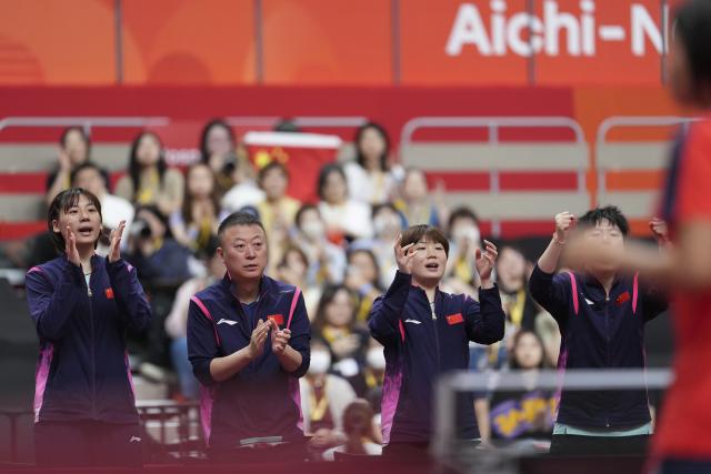 (260923) -- TOYOTA, Sept. 23, 2026 (Xinhua) -- Chen Yi (1st L), Kuai Man (3rd L) and Ma Lin (2nd L), coach of China, react during the women's team semifinal match between China and the Democratic People's Republic of Korea (DPRK) at the 20th Asian Games Aichi-Nagoya 2026 in Toyota of Aichi Prefecture, Japan, Sept. 23, 2026. (Xinhua/Cheong Kam Ka)
