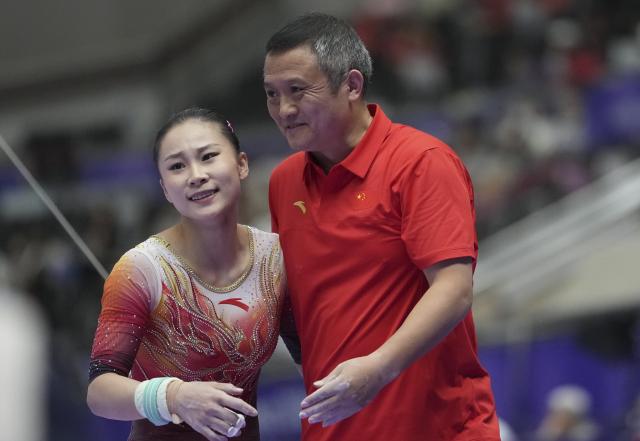 (260923) -- NAGOYA, Sept. 23, 2026 (Xinhua) -- Du Siyu (L) of China reacts during the uneven bars competition of the women's team final of Artistic Gymnastics at the 20th Asian Games Aichi-Nagoya 2026 in Nagoya, Japan, Sept. 23, 2026. (Xinhua/Lui Siu Wai)