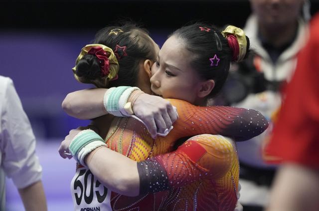 (260923) -- NAGOYA, Sept. 23, 2026 (Xinhua) -- Du Siyu (R) of China hugs teammate Qiu Qiyuan during the women's team final of Artistic Gymnastics at the 20th Asian Games Aichi-Nagoya 2026 in Nagoya, Japan, Sept. 23, 2026. (Xinhua/Lui Siu Wai)