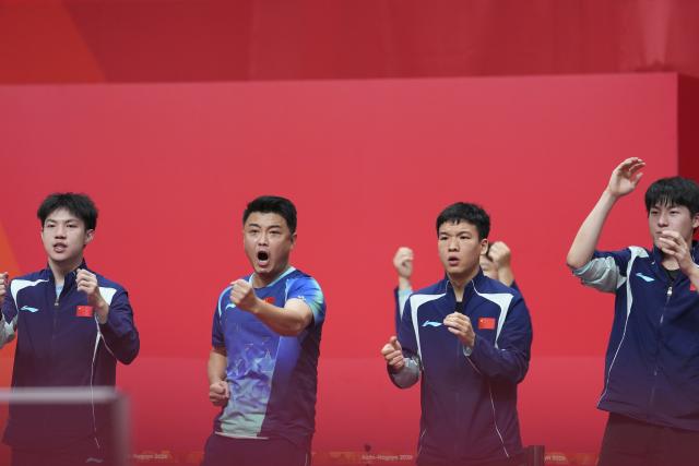 (260923) -- TOYOTA, Sept. 23, 2026 (Xinhua) -- Huang Youzheng (1st L), Xiang Peng (2nd R), Wen Ruibo (1st R) and Wang Hao, coach of China, celebrate during the men's team semifinal match between China and Chinese Taipei at the 20th Asian Games Aichi-Nagoya 2026 in Toyota of Aichi Prefecture, Japan, Sept. 23, 2026. (Xinhua/Cheong Kam Ka)